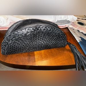 Black clutch handbag with half moon woven design made by Bloomingdales.